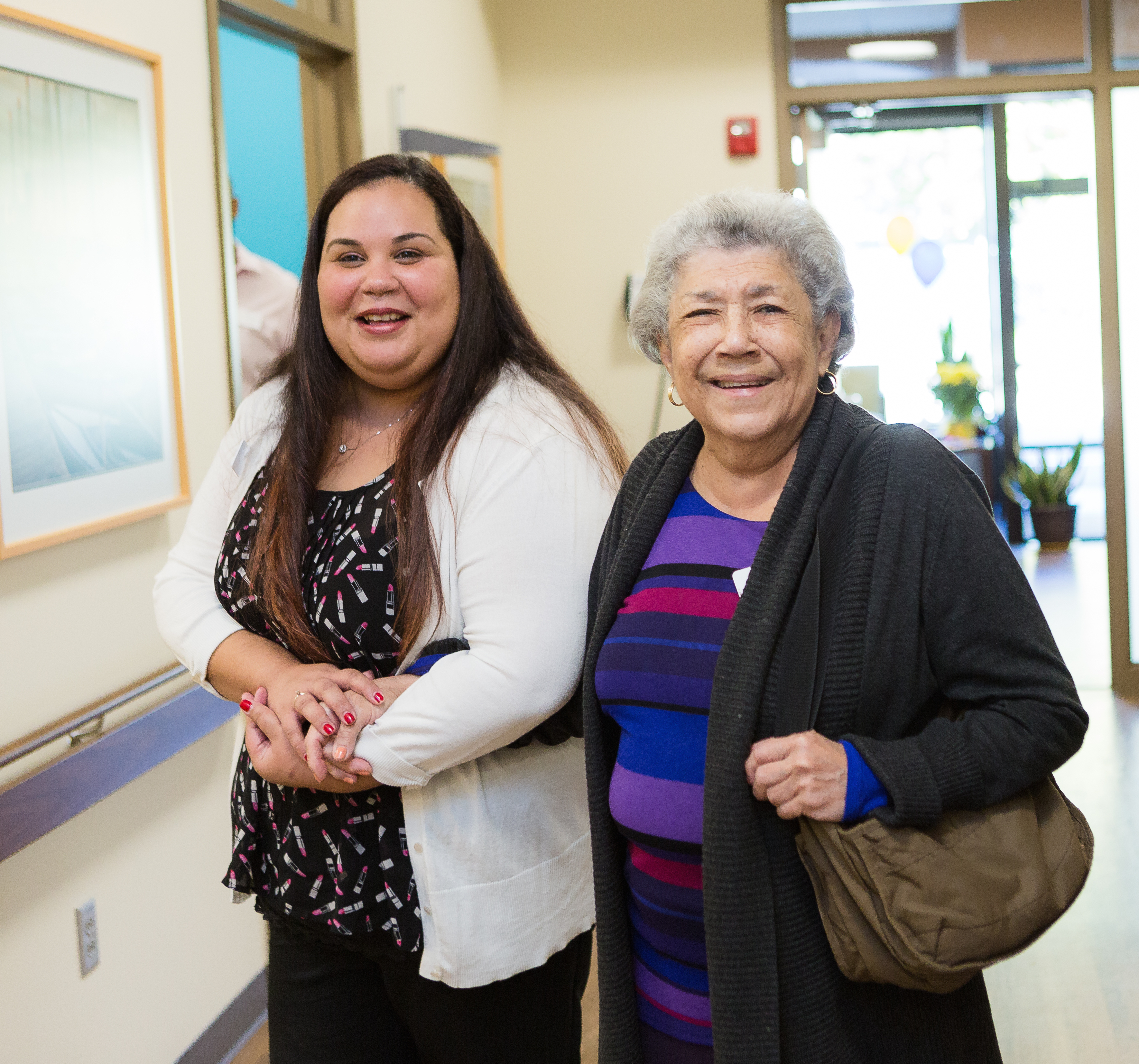 Iora Primary Care health coach Brendalys Rosario takes senior Marina Haley on a tour of the new Iora practice in Hyde Park, Mass.